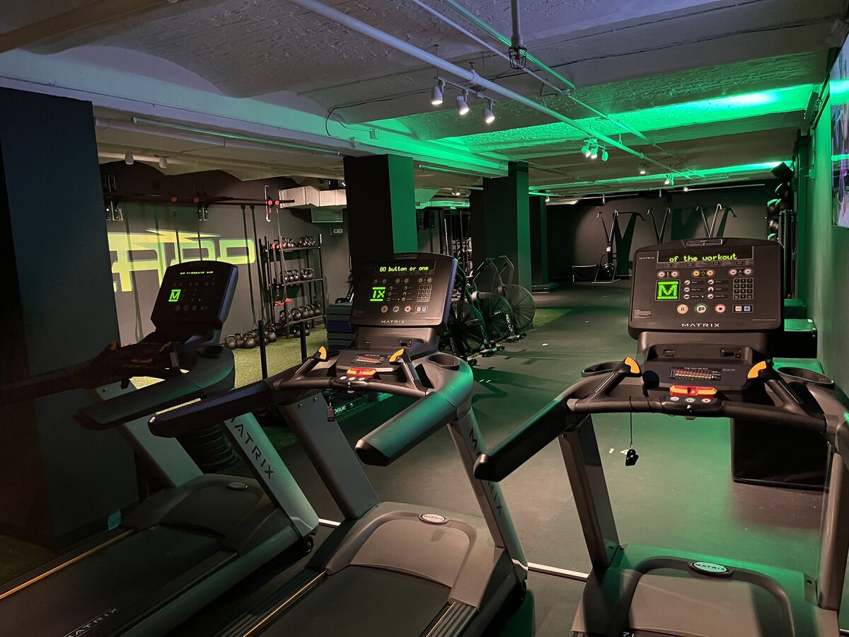 Treadmills overlooking the open training floor and turf area