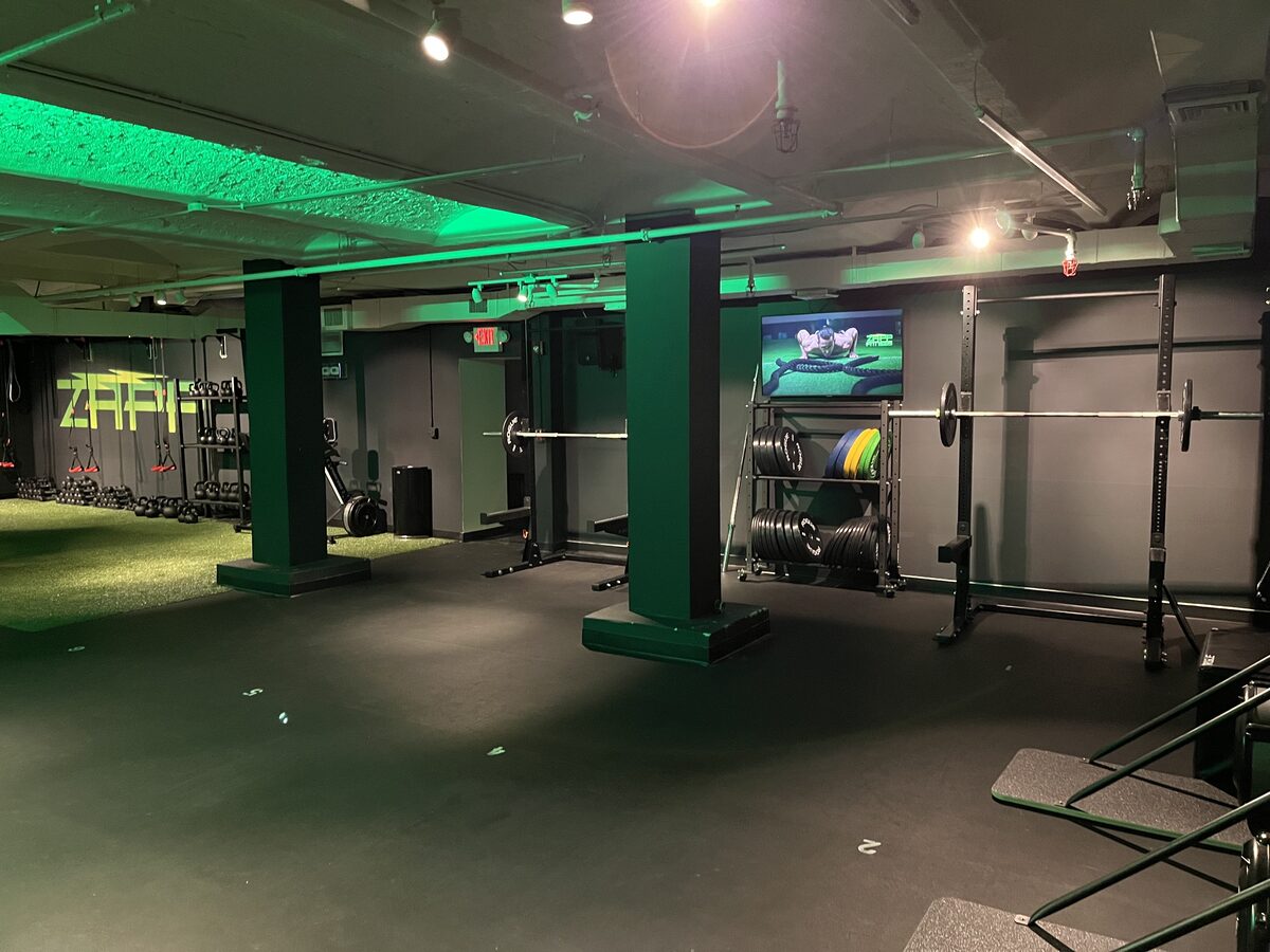 Strength area with squat racks, barbells, and bumper plates